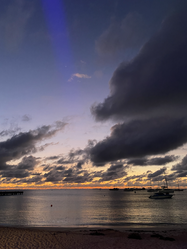 The sky is shot through with many colors over the waters in Anguilla as the sun sets.